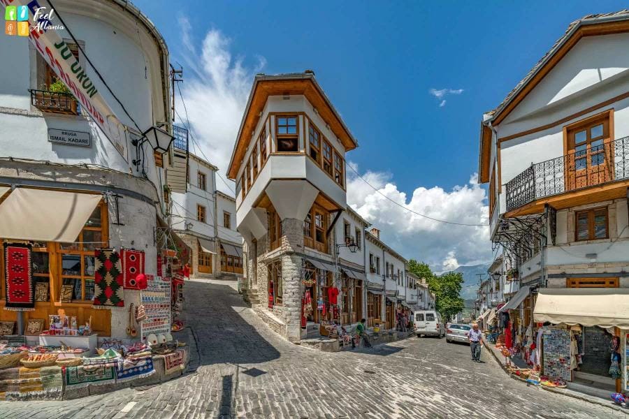 Gjirokastra cobblestone street with iconic Ottoman stone houses and castle