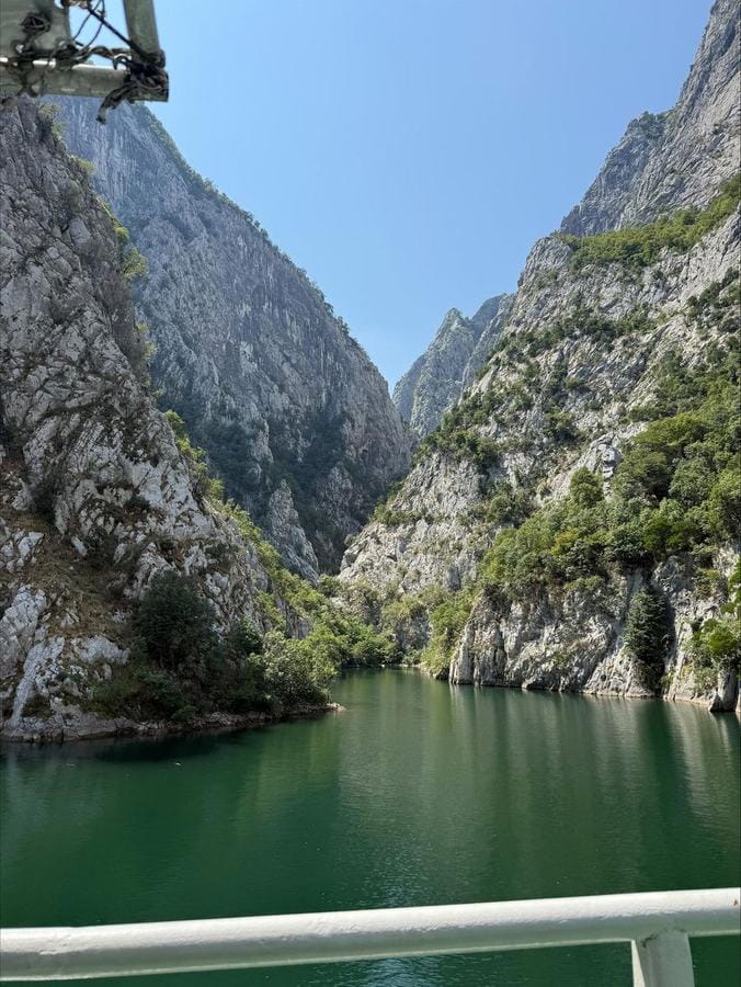 Komani Lake fjord-like waters with dramatic mountain cliffs